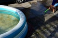 cracked plastic inflatable pool for children. the blue circle from