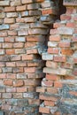 Cracked red brick wall. Old dirty stained damaged brick wall with scratches and traces of destruction Royalty Free Stock Photo