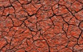 Cracked red dry earth background. Old earth with cracks, top view. Red old dry earth with cracks Royalty Free Stock Photo