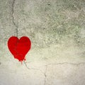 Cracked red heart on concrete wall Royalty Free Stock Photo