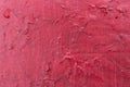 Cracked red paint texture. Close-up of old painted red wall. Abstract grunge background. Vintage scratched surface Royalty Free Stock Photo