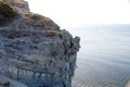 A cracked rock on a cliff by the sea