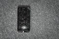 Cracked screen of smartphone mobile black glasses top view photography.