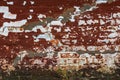 cracked shabby brick wall with old layers of brown and white paint Royalty Free Stock Photo