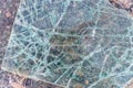 Cracked and shattered glass. Abstract texture and background. Broken glass close-up on the ground Royalty Free Stock Photo