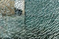 Cracked, shattered glass with urban reflections. Vandalism Royalty Free Stock Photo