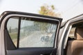 Cracked side car window glass on road . Damaged car window. .Car accident claims via insurance apps