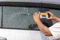 Cracked side car window glass on road . Damaged car window. Car accident claims via insurance apps