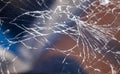 Cracked smart phone screen close-up. Broken glass texture background with cracks