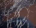 Cracked smart phone screen close-up. Broken glass texture background with cracks