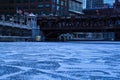 Cracked and snow covered ice in a low-angle view of a frozen Chicago River on a blue and frigid morning Royalty Free Stock Photo