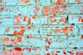 Cracked soft turquoise paint, plaster surface on red brick wall, grunge horizontal shabby background detail Royalty Free Stock Photo