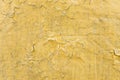 Cracked toxic yellow paint texture. Close-up of old painted red wall. Abstract grunge background. Vintage scratched surface Royalty Free Stock Photo