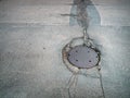 Manhole on old cracked city streets