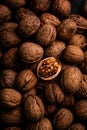 Cracked walnut in pile of whole walnuts Royalty Free Stock Photo