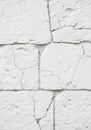 Cracked white textured wall made of plaster or similar material. Rectangular blocks Royalty Free Stock Photo