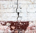 Cracked whitewashed brick wall