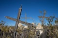 Cracked wooden crosses in abandoned cemetery