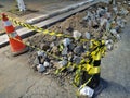 Cracked and worn asphalt on a street work. Broken concrete on a public way. Cones delimiting street work area in Sao Paulo, Brazil Royalty Free Stock Photo