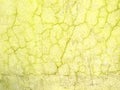 Cracked yellow ragged wall background texture