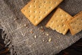 Cracker sandwiches with chocolate filling on black background.