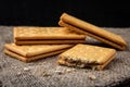 Cracker sandwiches with chocolate filling on black background.