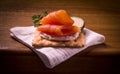 Cracker and smoked salmon on wooden table Royalty Free Stock Photo