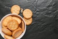 Cracker stacked in white bowl over black granite