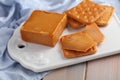 Crackers with Brunost, Norwegian Brown Cheese on ceramic board Royalty Free Stock Photo
