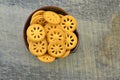 Crackers with few calories on black bowl on wooden table