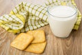 Crackers, glass of milk and checkered napkin on table Royalty Free Stock Photo