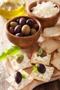 Crackers with soft cheese and olives. healthy appetizer