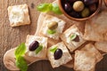 Crackers with soft cheese and olives. healthy appetizer