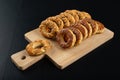 Crackers sprinkled with salt on a wooden board. Salty snack for an evening party