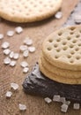 Crackers stack together on black stone, coarse sugar on wooden b Royalty Free Stock Photo