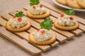 Crackers with tuna salad on wooden plate