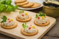 Crackers with tuna salad on wooden plate and tuna spread in canned Royalty Free Stock Photo