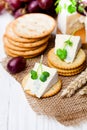 Crackers and wedge of blue camembert cheese on sackcloth napkin Royalty Free Stock Photo
