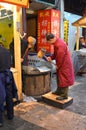 Chinese Food - Two men cracking the grain for Noodle flour, Xi'an, China