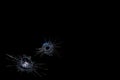 Cracks on a black background on broken glass from bullet shots Royalty Free Stock Photo
