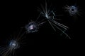 Cracks on a black background on broken glass from bullet shots Royalty Free Stock Photo