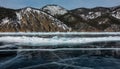 Cracks and blocks of hummocks are visible on the ice of the frozen lake Royalty Free Stock Photo