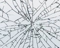 Cracks in the form of a web on the glass, the texture of a broken window. Abstraction on a white background. Royalty Free Stock Photo