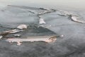 Cracks with ice crystals on frozen river at sunset Royalty Free Stock Photo