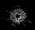 Bullet hole in the glass. Isolated on a black background. Royalty Free Stock Photo