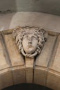 The face of the woman as the headstone of the portal.