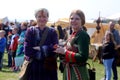 Two young women wearing Viking style outfits and jewelry