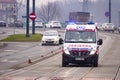 Cracow, Poland 12.17.2019: emergency ambulance rides with flashing lights to help patient on tram tracks. give road service with