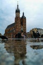 Facade of St. Mary`s Church reflected in puddle Royalty Free Stock Photo