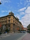 Cracow Poland old tenement house blue sky white clouds people street Royalty Free Stock Photo